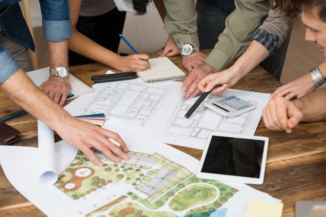 group of people looking at landscape and architectural drawings